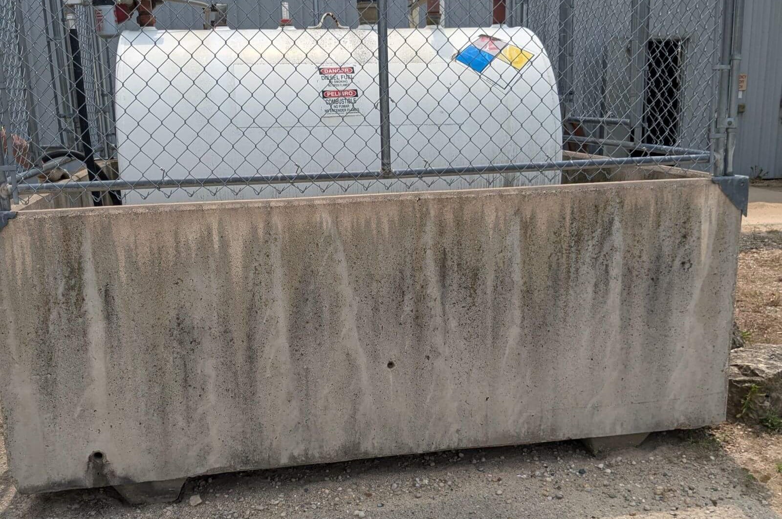 Custom concrete box for metal tank